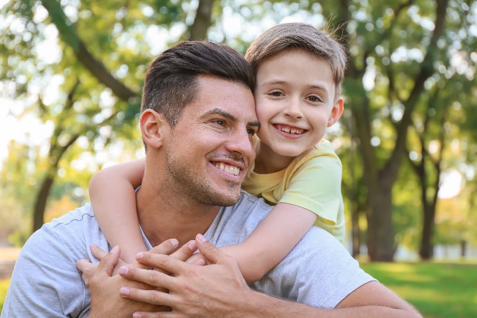 Father and son hugging in the park