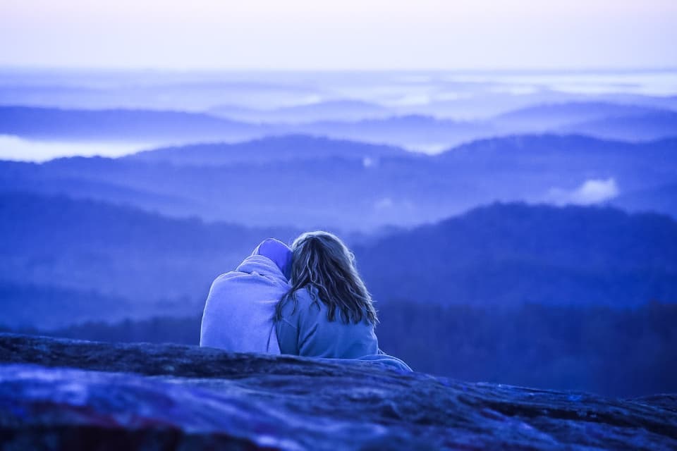 Wrapped in a blanket above blue mountains