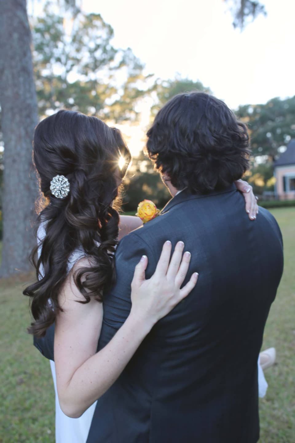 Close-up of the bride's hair and the groom's jacket