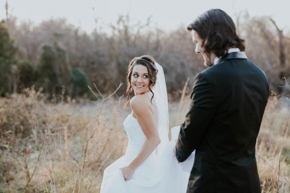 Bride and groom in a golden field
