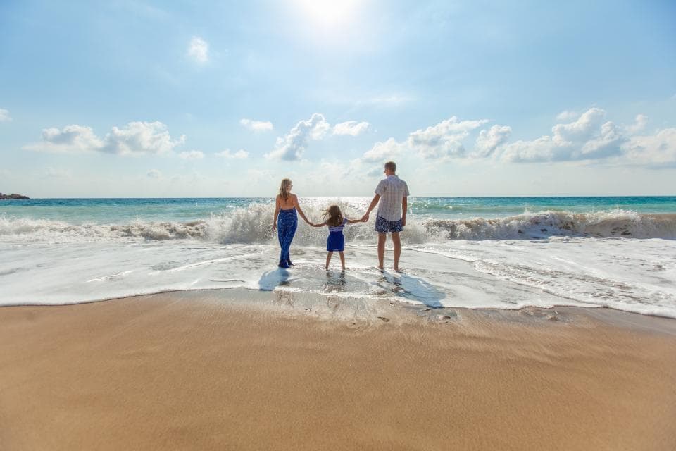 Family walking into the waves