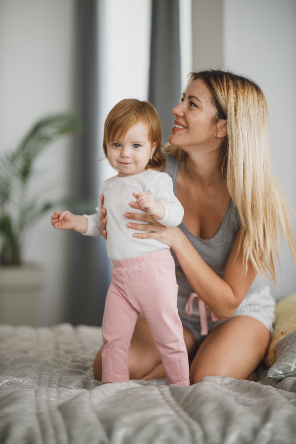 A mother playing with her toddler at home